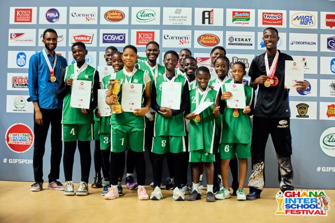 Girls athletics team celebrating with their medals