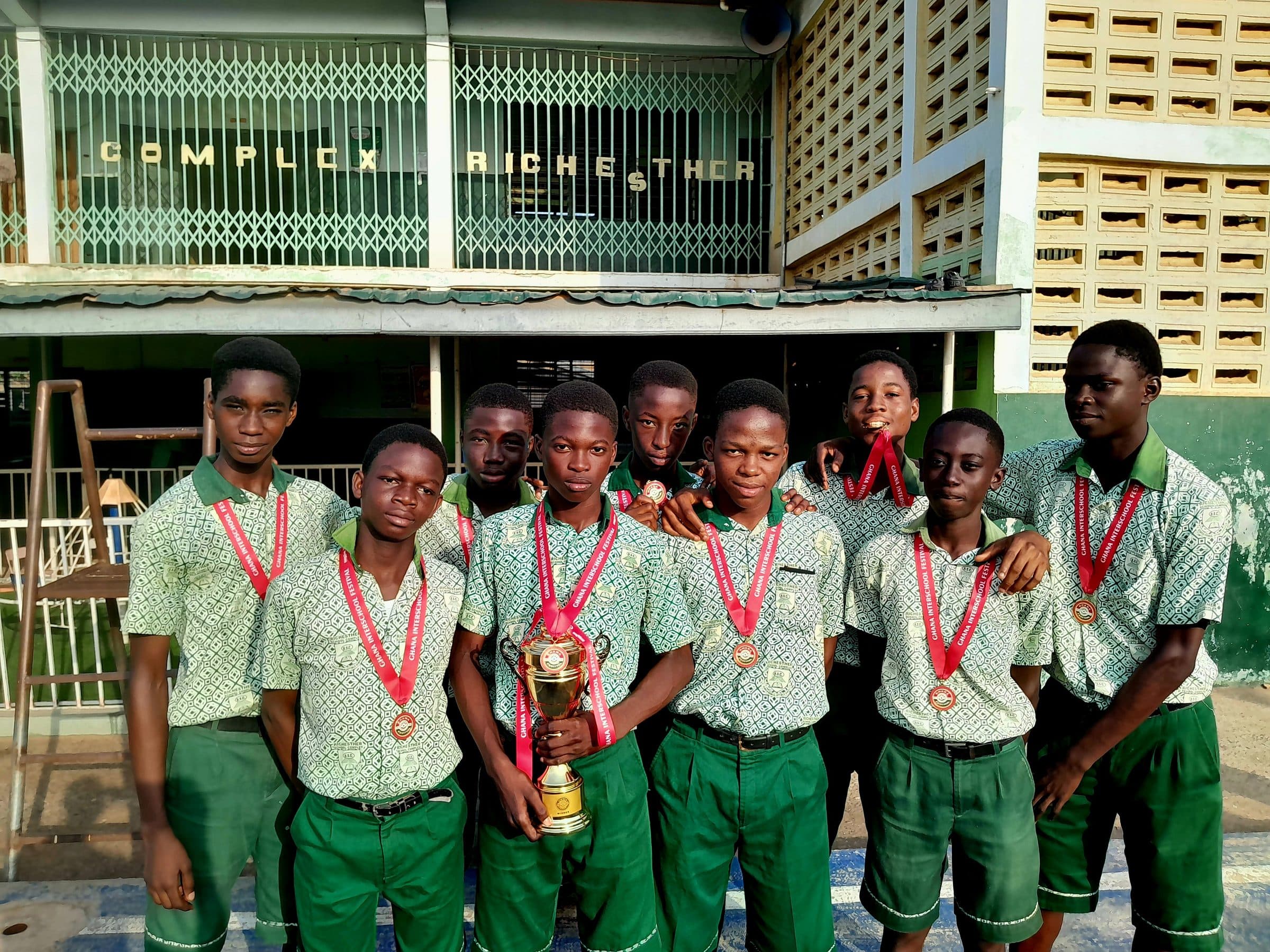 Richesther students posing together with an award outside the school building